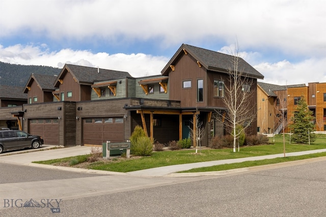 view of front of house featuring a garage and a front lawn