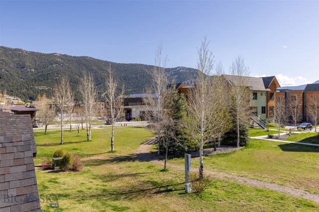 exterior space with a mountain view and a lawn