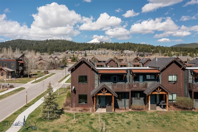 view of front facade with a front lawn and a mountain view