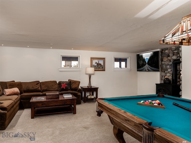 rec room with a wood stove, light carpet, and pool table