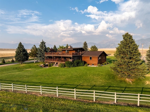 exterior space featuring a mountain view, a front lawn, and a rural view