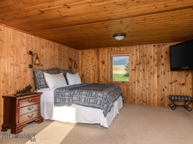 carpeted bedroom featuring wooden ceiling and wooden walls