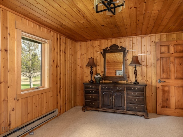 interior space featuring wood walls, carpet flooring, wood ceiling, and a baseboard radiator