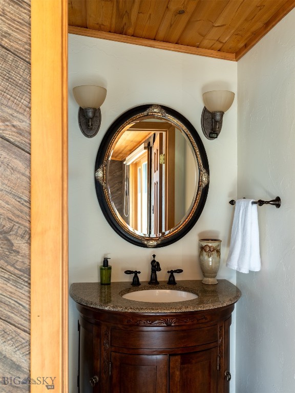 bathroom featuring wood ceiling, vanity, and ornamental molding