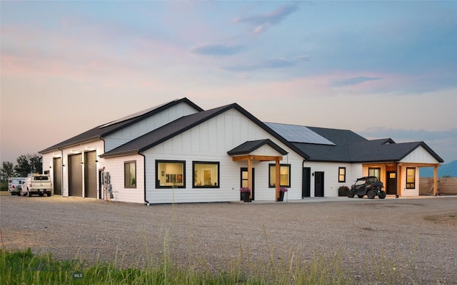 modern inspired farmhouse featuring a garage and solar panels