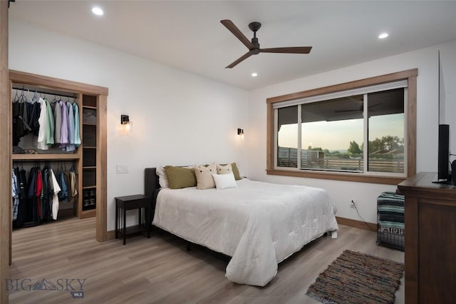 bedroom with ceiling fan, light wood-type flooring, and a closet