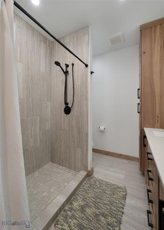 bathroom featuring vanity and walk in shower