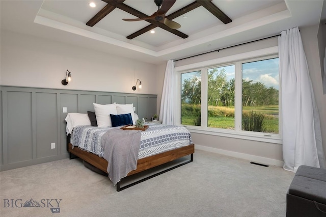 carpeted bedroom featuring coffered ceiling, ceiling fan, and beamed ceiling