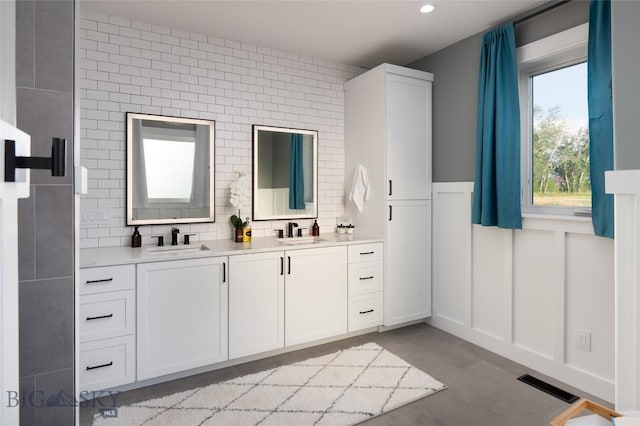 bathroom with vanity, hardwood / wood-style floors, and backsplash