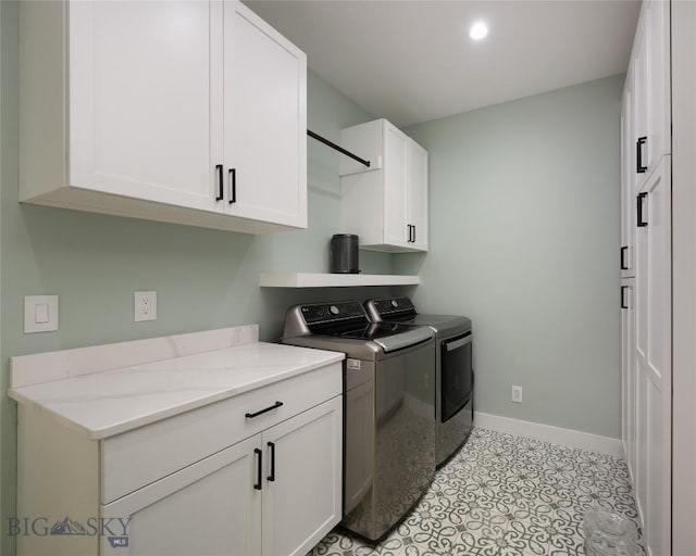 laundry area featuring cabinets and washing machine and dryer