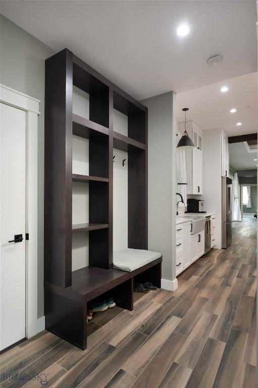 mudroom with dark hardwood / wood-style floors and sink