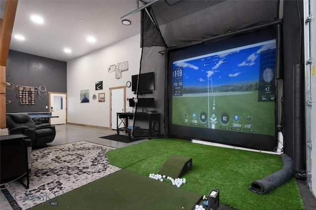 recreation room with golf simulator and concrete flooring