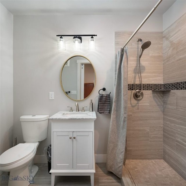 bathroom with vanity, toilet, and walk in shower