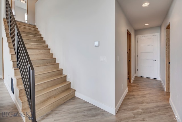 stairs featuring wood-type flooring