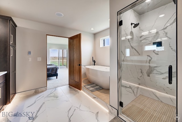 bathroom with tile patterned flooring, independent shower and bath, and vanity