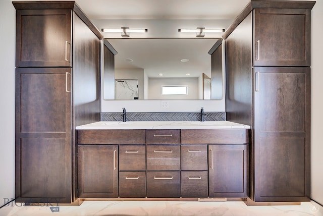 bathroom featuring tile patterned floors and dual bowl vanity