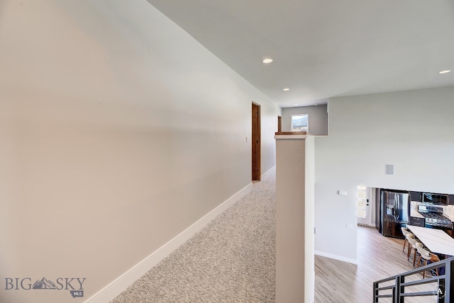 hallway featuring light colored carpet