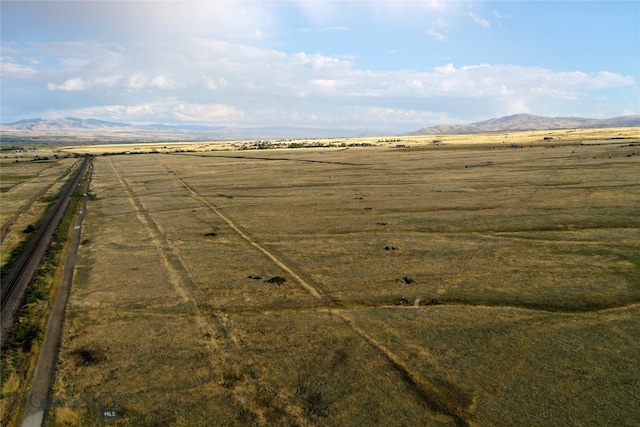 view of yard with a mountain view and a rural view