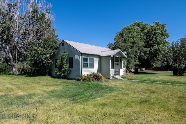 view of side of property with a yard