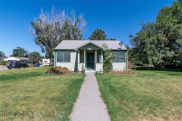 bungalow-style home with a front yard