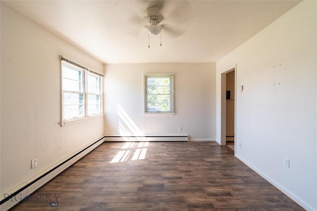 spare room featuring ceiling fan, baseboard heating, and wood-type flooring