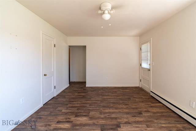 spare room with ceiling fan, a baseboard heating unit, and wood-type flooring