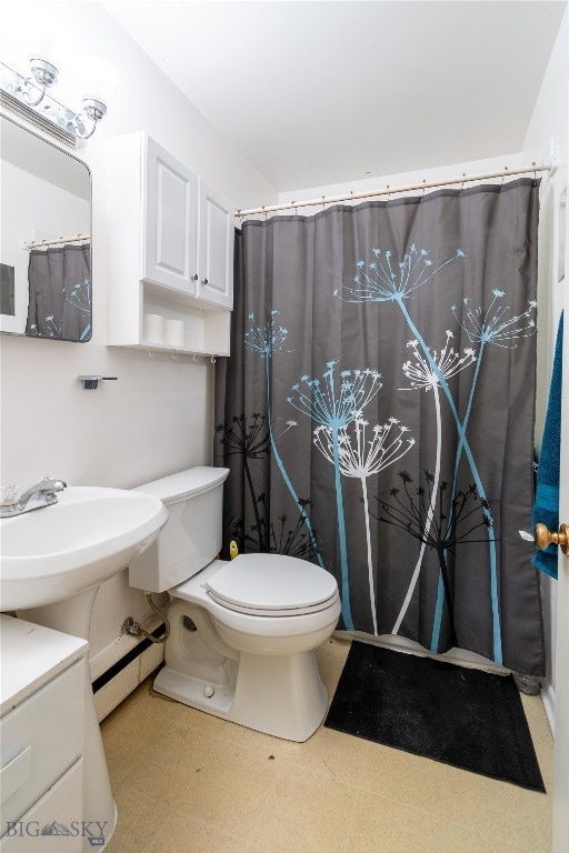 bathroom featuring vanity, toilet, tile patterned floors, and a baseboard heating unit