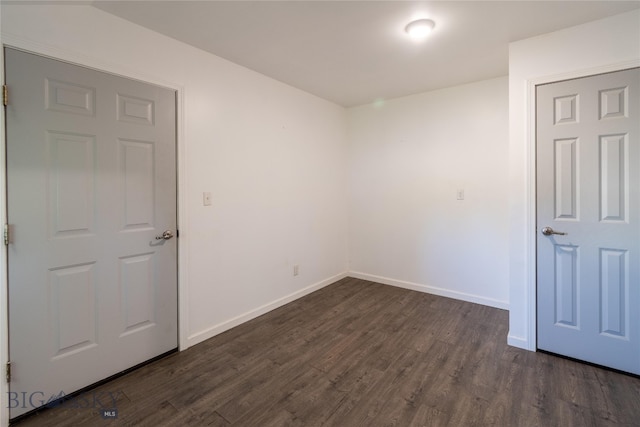 empty room with dark hardwood / wood-style floors