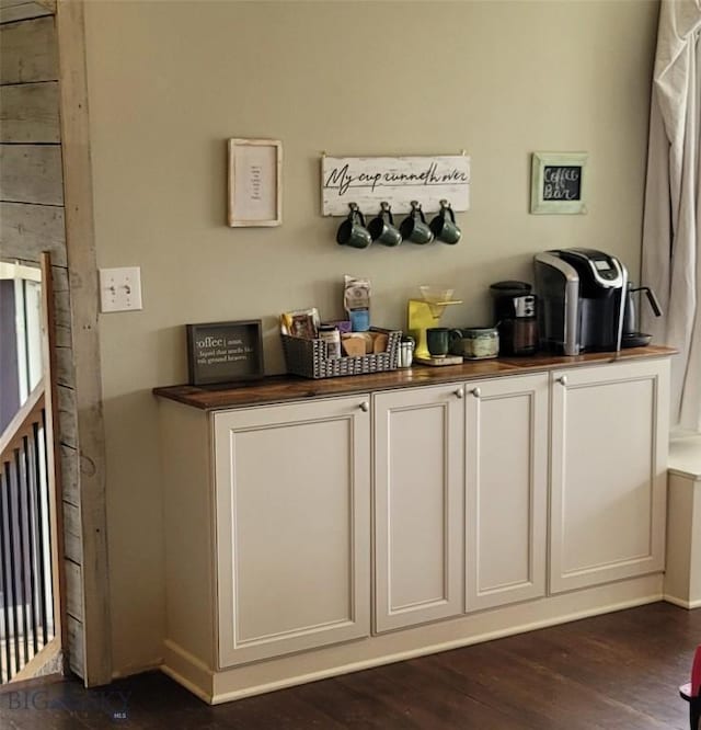 bar featuring dark wood-style floors