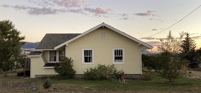 view of back of house at dusk