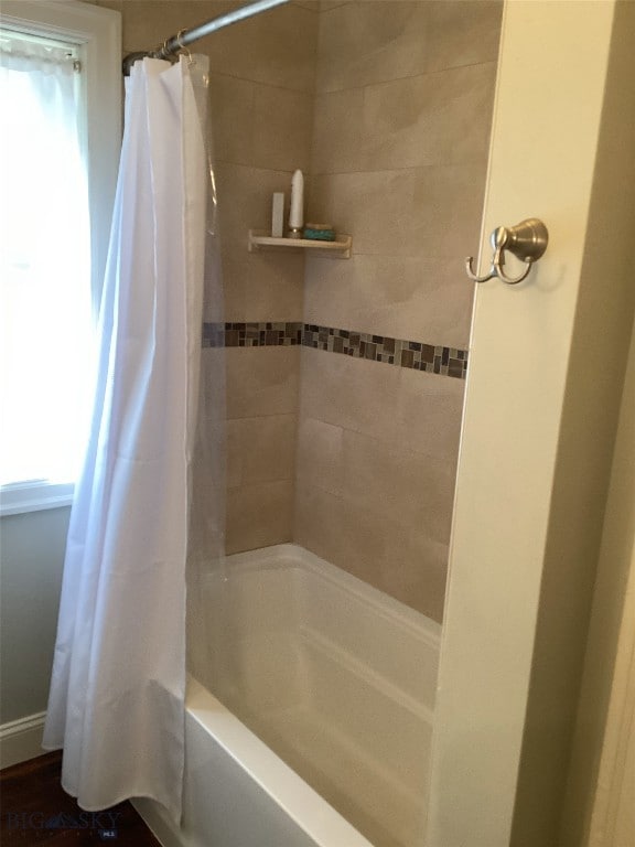 bathroom with shower / tub combo and a healthy amount of sunlight