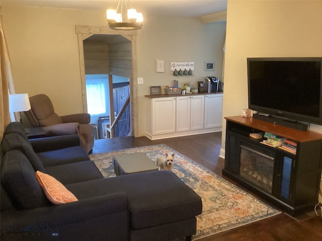 living room featuring dark wood-type flooring and a notable chandelier