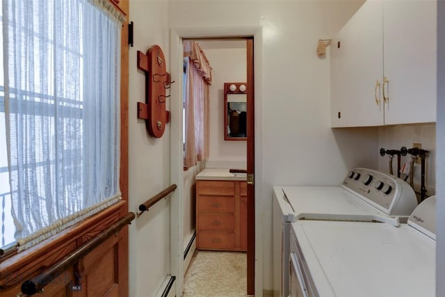 laundry room featuring a baseboard radiator, washer and clothes dryer, baseboard heating, and cabinet space