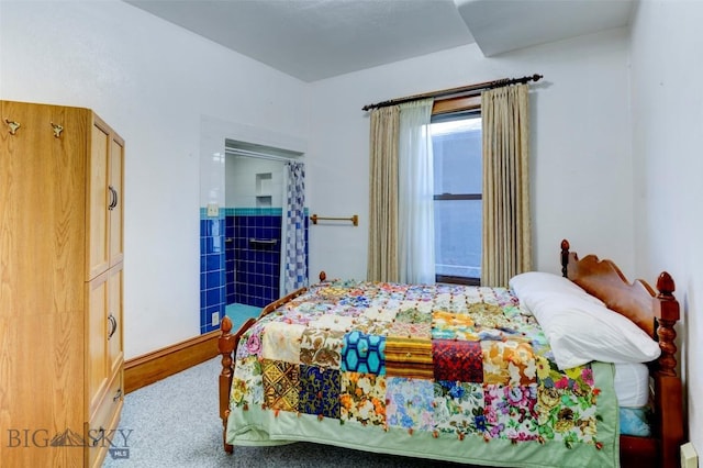 carpeted bedroom featuring baseboards