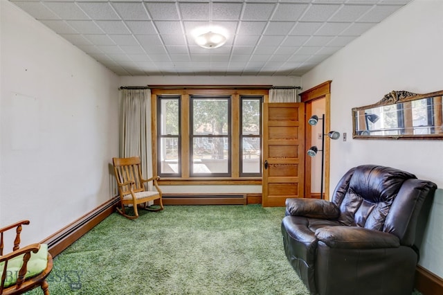 sitting room featuring a baseboard radiator and carpet flooring