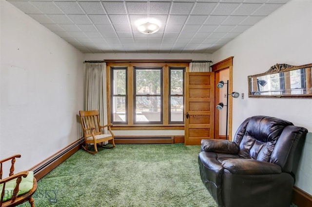 living area featuring a baseboard heating unit and carpet floors