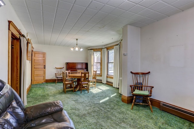 living room featuring carpet floors, an inviting chandelier, and a baseboard heating unit