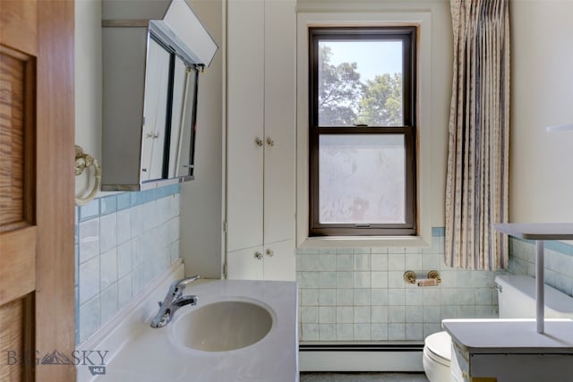 bathroom with tile walls, toilet, a baseboard radiator, and vanity