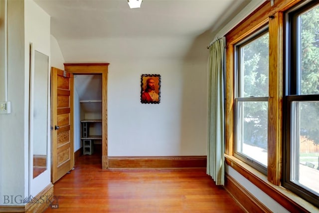 hall with light wood-type flooring, plenty of natural light, and baseboards