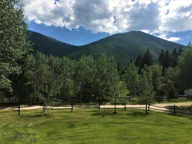 property view of mountains featuring a view of trees and a rural view