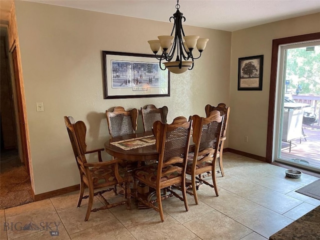 dining area with light tile patterned flooring, baseboards, and a chandelier