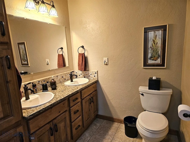 bathroom featuring vanity, tile patterned flooring, and toilet