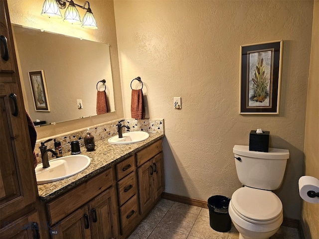 full bath featuring a sink, tile patterned flooring, toilet, and double vanity