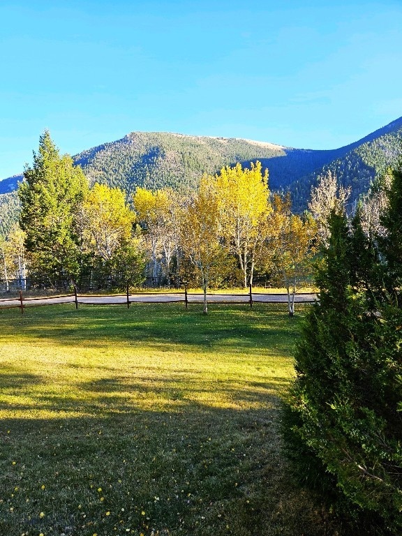 view of property's community with a lawn and a mountain view