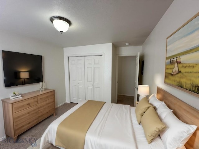 bedroom with a closet and dark colored carpet