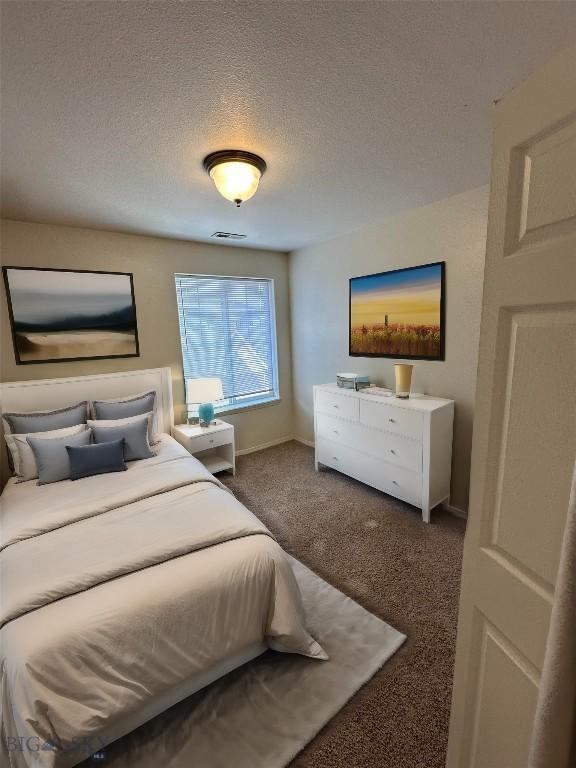 carpeted bedroom featuring a textured ceiling