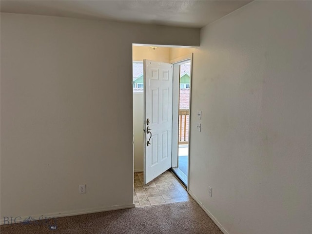 view of carpeted foyer