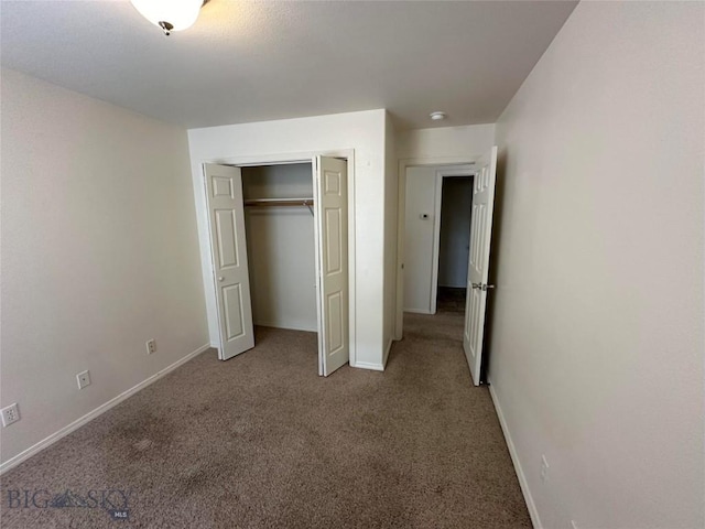 unfurnished bedroom featuring a closet and light carpet