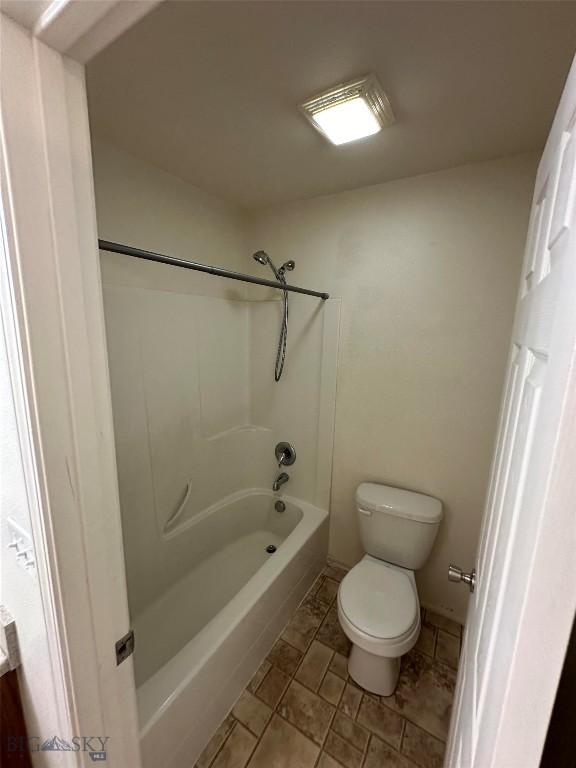 bathroom featuring toilet and shower / bath combination