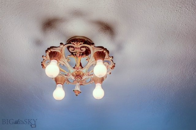 exterior details with an inviting chandelier and a textured ceiling